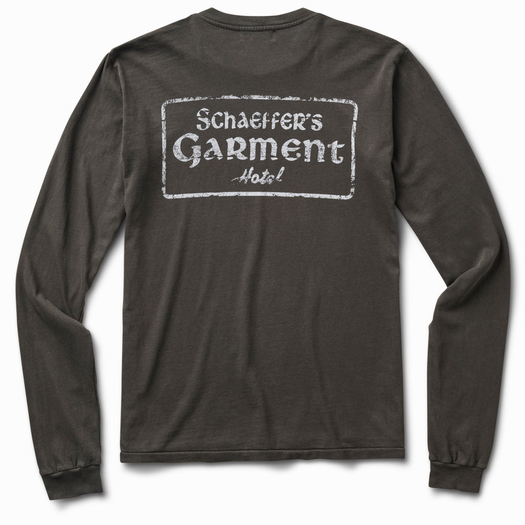 Charcoal grey long sleeve tee, back view, with a distressed white Schaeffer's Garment Hotel stamp print