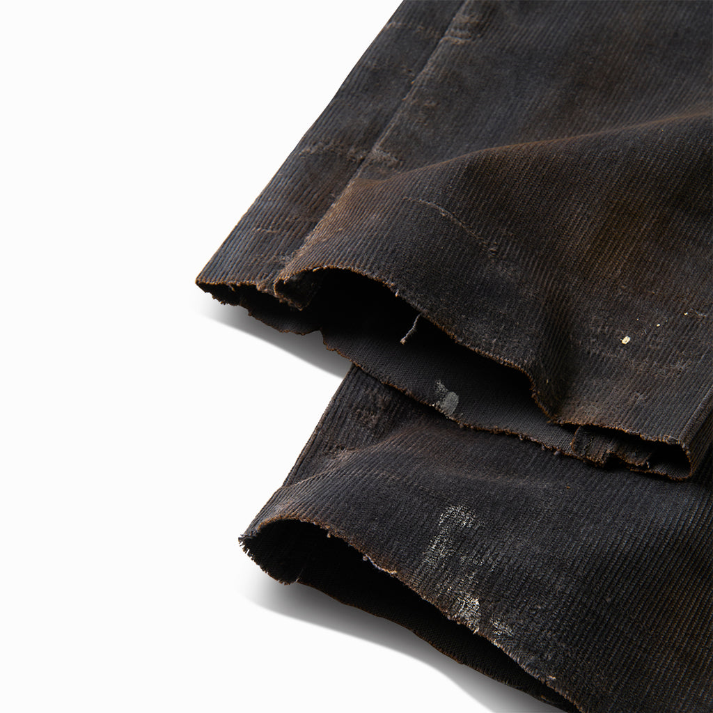 Close-up of the frayed raw hems on the distressed corduroy chino