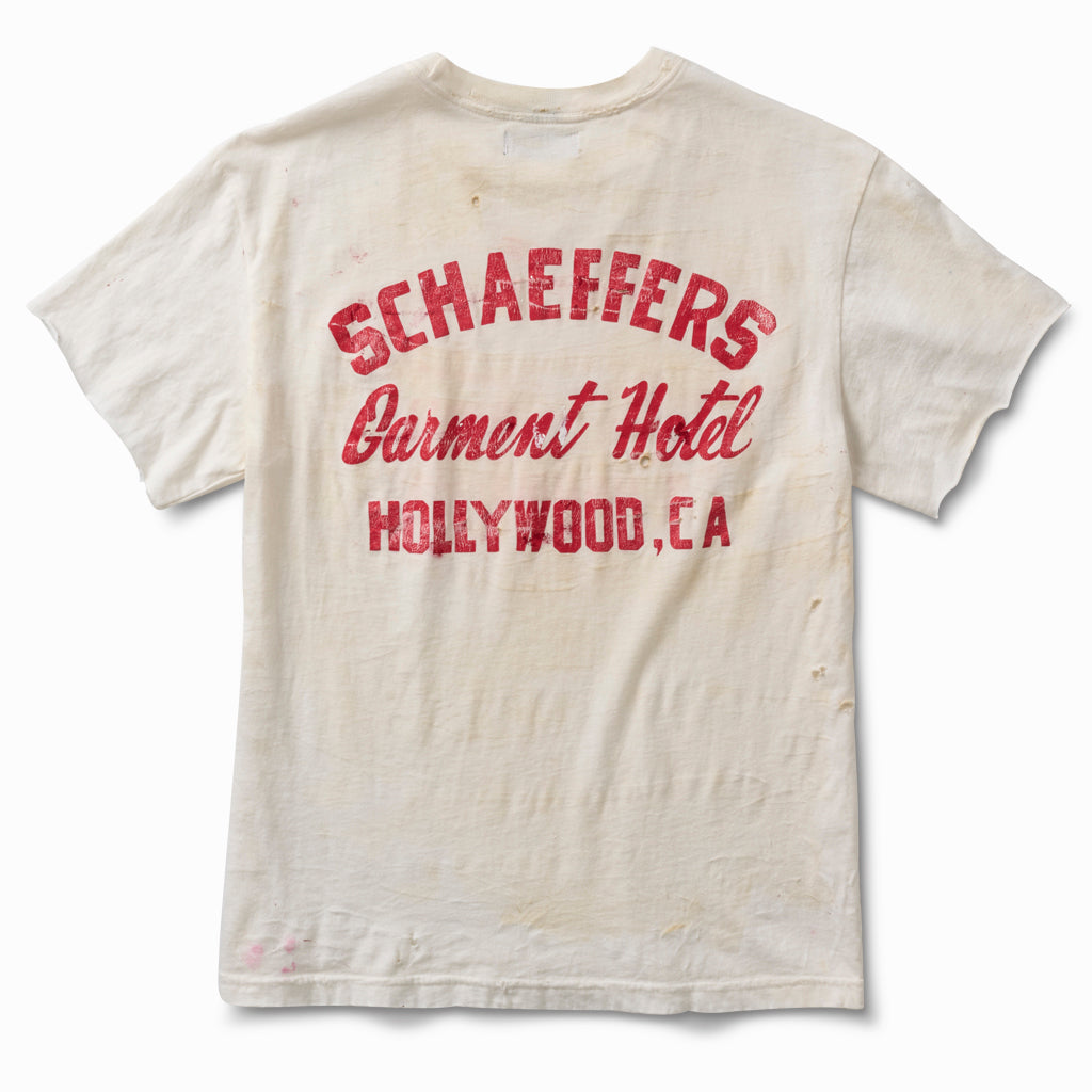 Dirty white tee, back view, with a red Schaeffers Garment Hotel Hollywood, CA script print