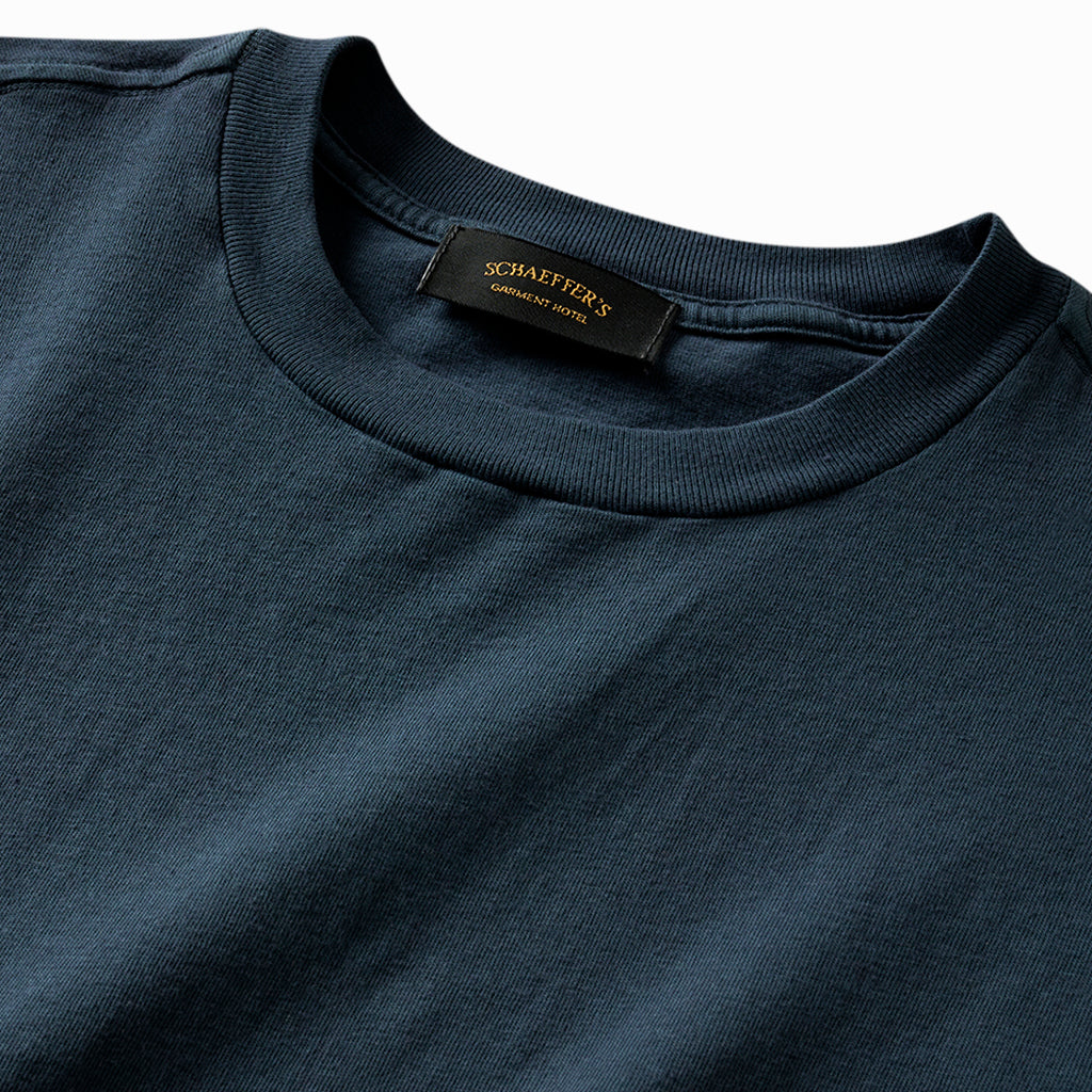 Close-up of the indigo tee's ribbed collar and Schaeffer's neck label