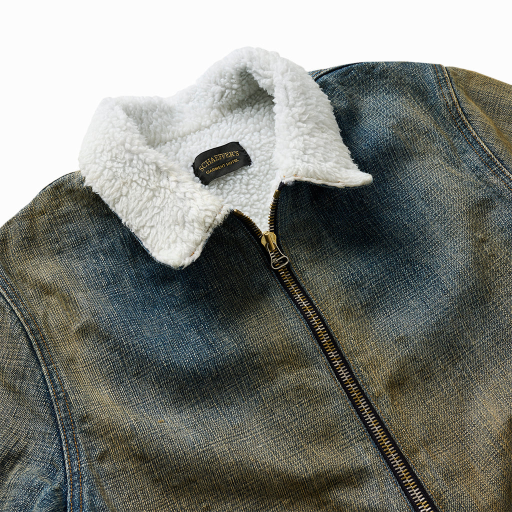 Close-up of the white shearling collar, brass zip and Schaeffer's label on the destroyed denim jacket