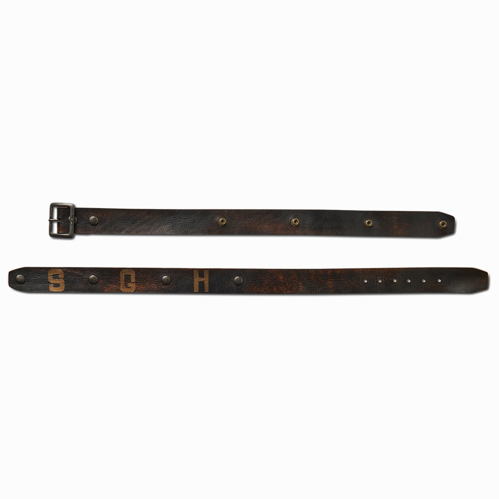 Black leather SGH belt laid flat in two pieces showing the studs and holes