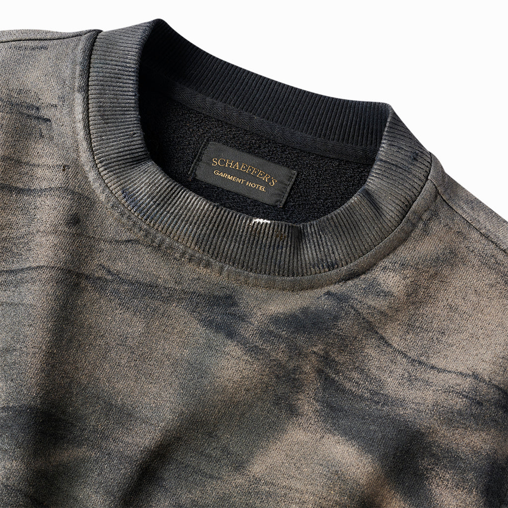 Close-up of the oil-stained crew sweatshirt's ribbed collar and Schaeffer's neck label