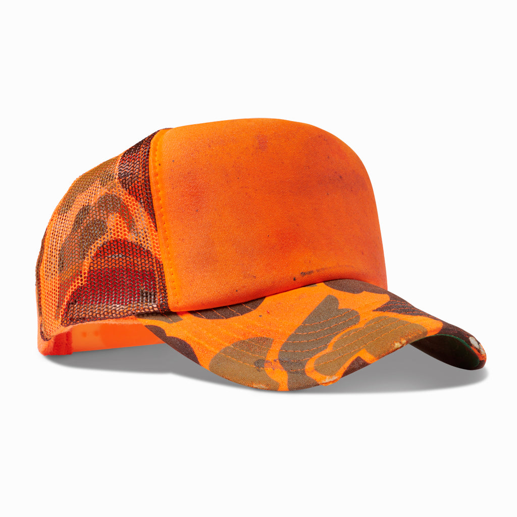 Orange and camo trucker hat, angled view showing the camo mesh back