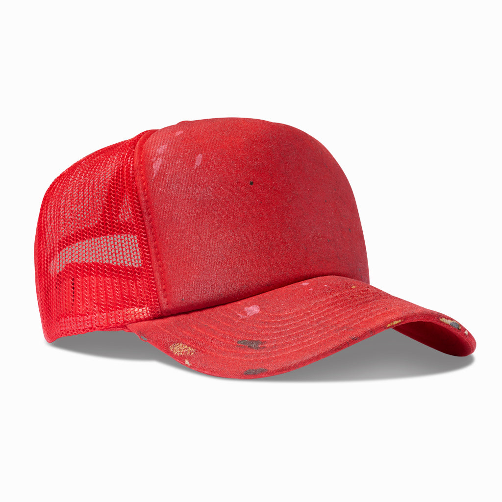 Red trucker hat, angled view showing the red mesh back and worn brim