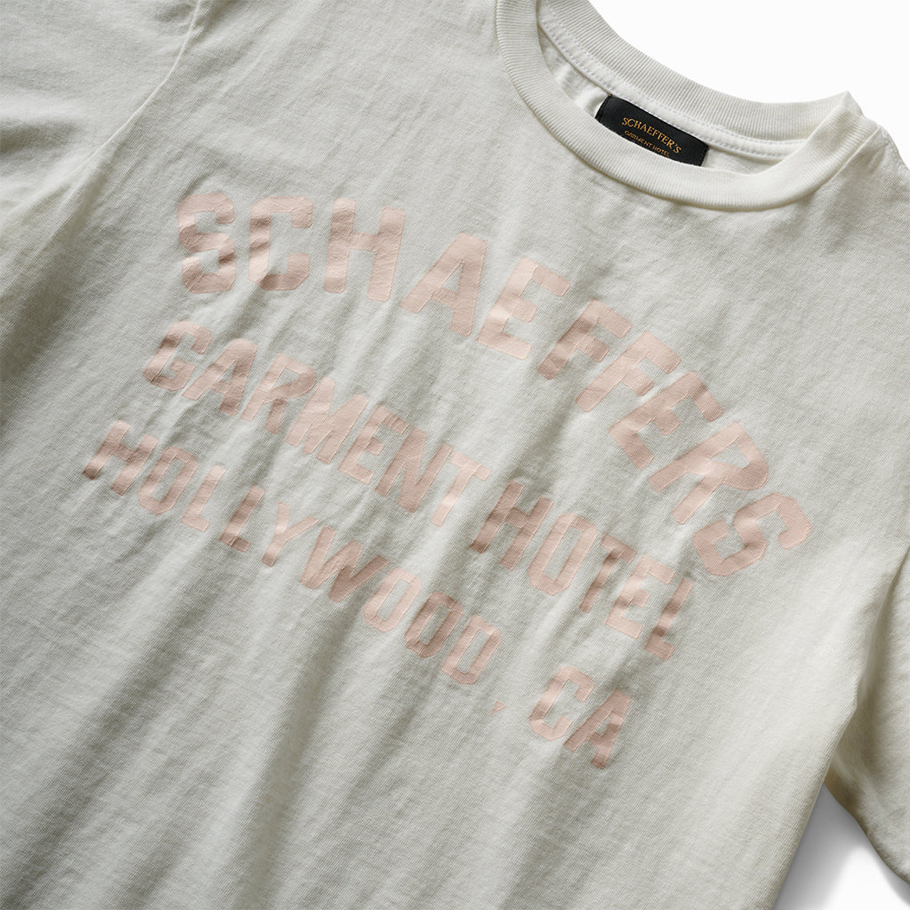 Close-up of the cracked pink Schaeffer's Garment Hotel print on the white tee