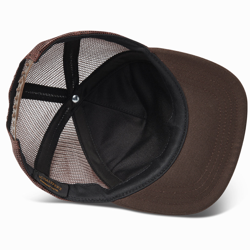 Inside of the brown trucker hat showing the lined crown and brim