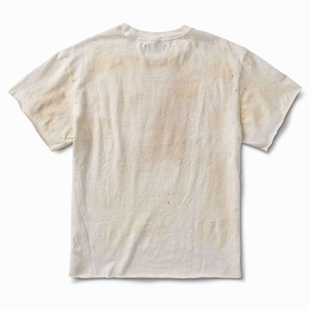 Distressed off-white tee, back view, with aged staining