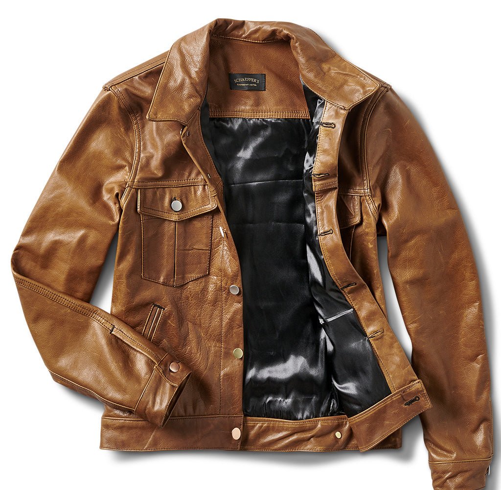Tan leather trucker jacket shown open to reveal the black satin lining