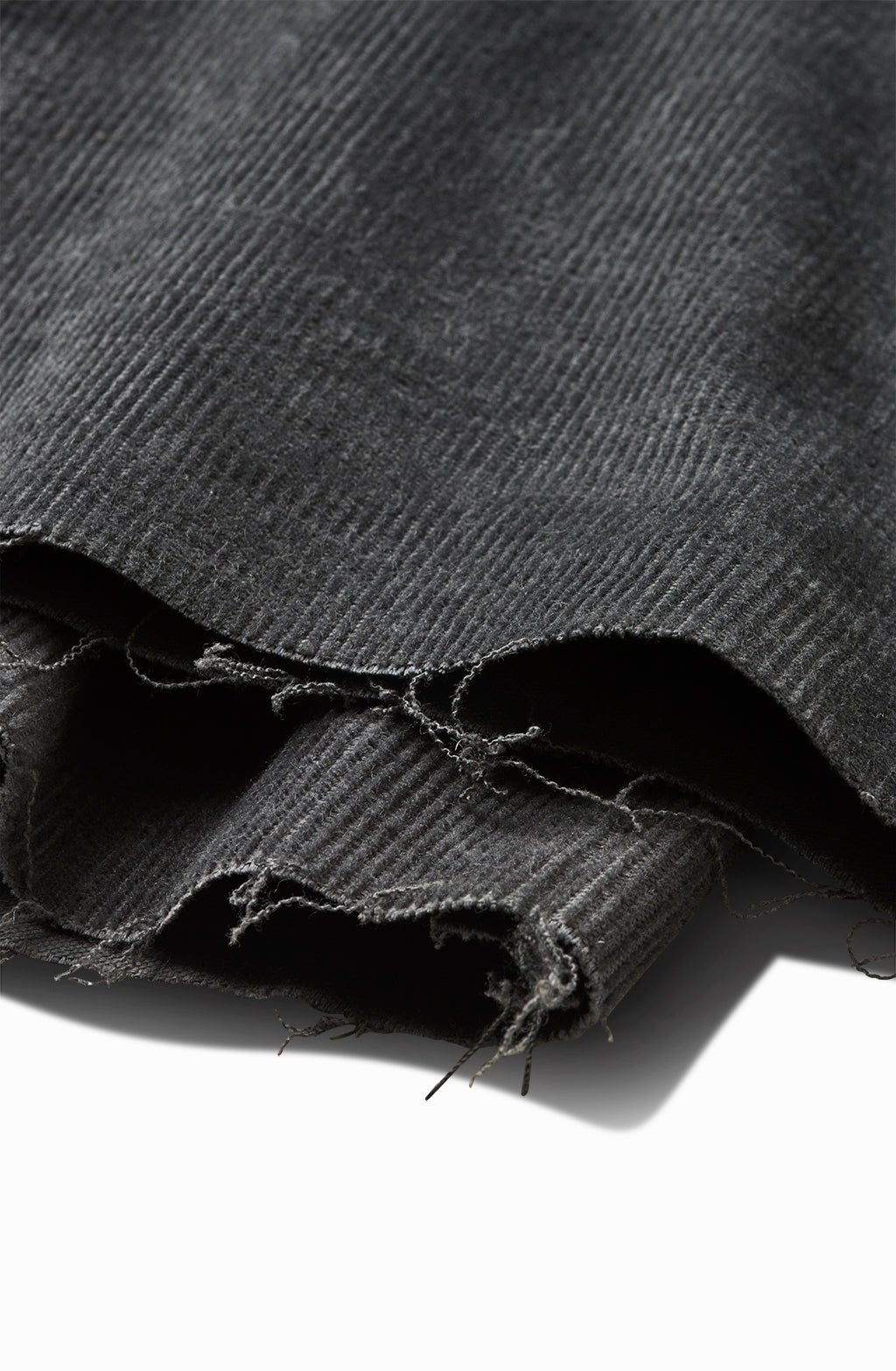 Close-up of the charcoal corduroy chino's frayed raw hem