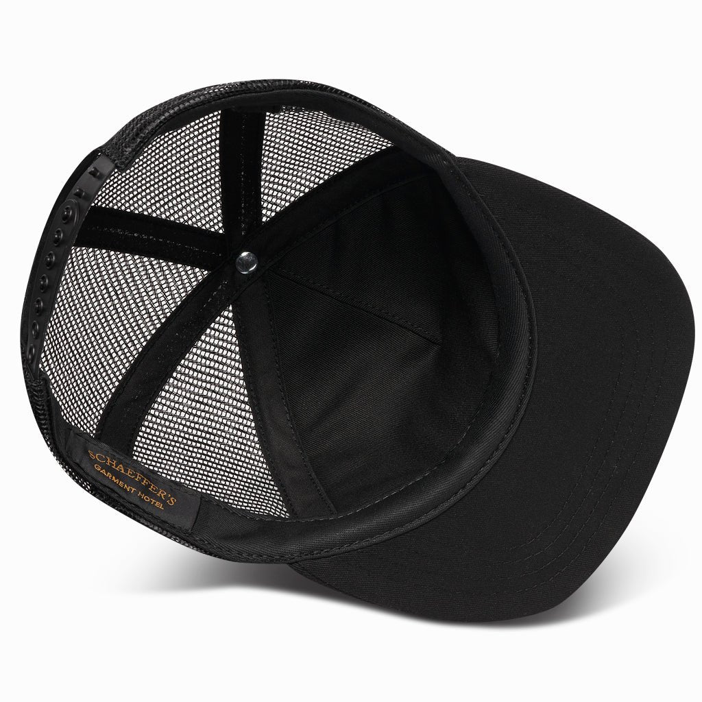 Underside of the black orange label trucker hat