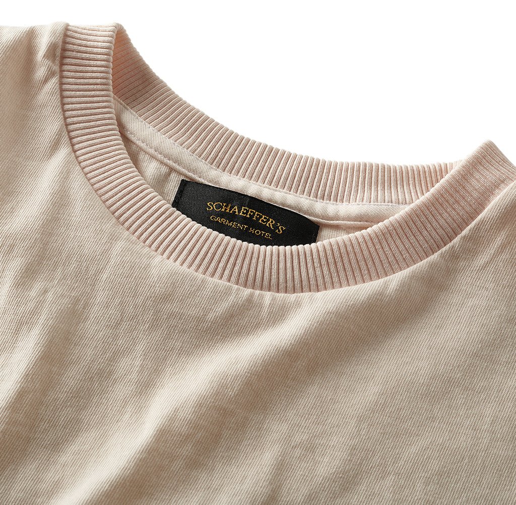 Close-up of the pink champagne pocket tee's ribbed collar and neck label