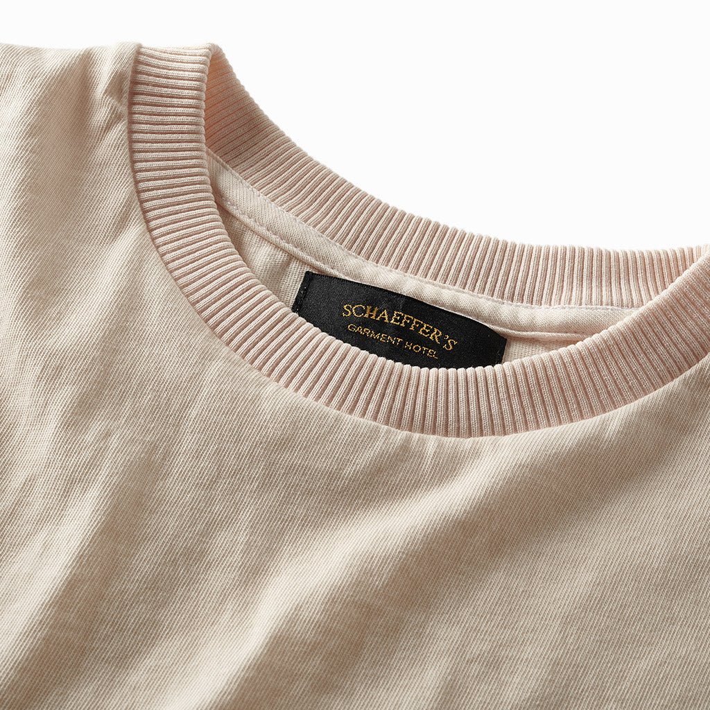 Close-up of the pink champagne tee's ribbed collar and Schaeffer's neck label