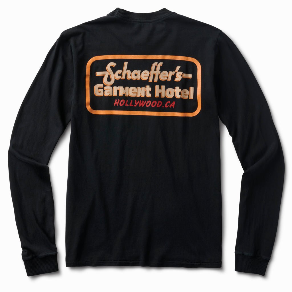Black long sleeve tee, back view, with a large orange Schaeffer's Garment Hotel Hollywood, CA script logo