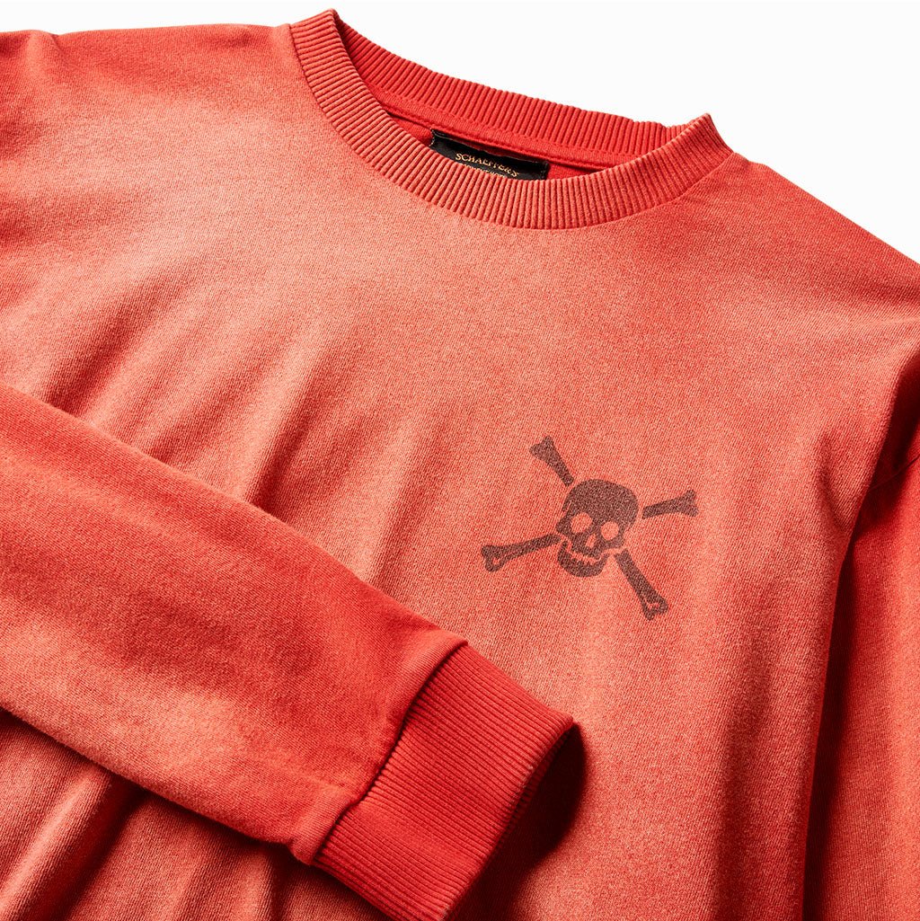 Close-up of the skull chest print and ribbed collar on the sun-faded red tee