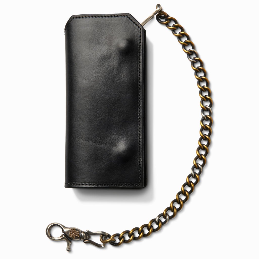Black leather trucker wallet closed with the brass wallet chain attached