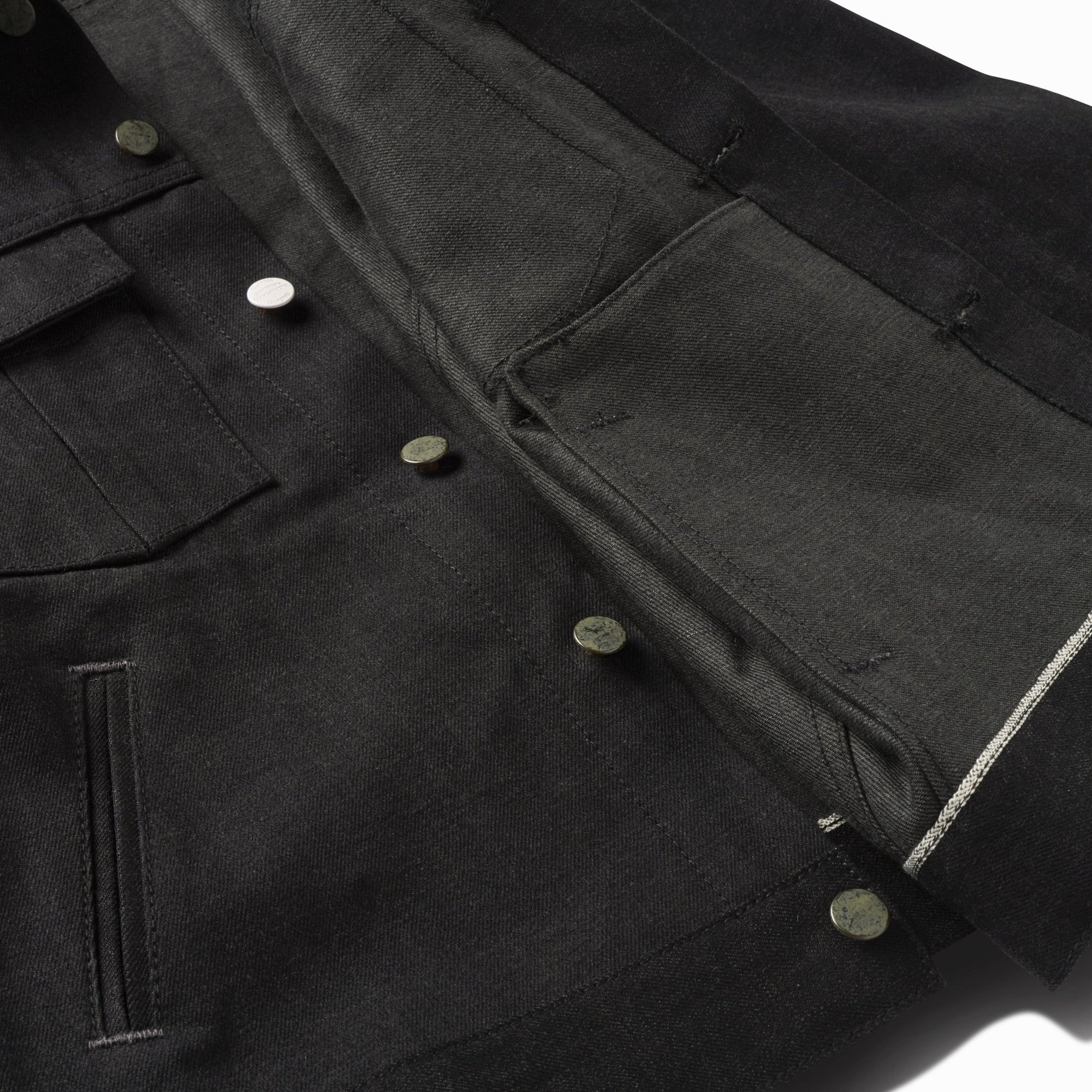 Close-up of the sulfur black jacket's hand pocket and selvedge inner placket