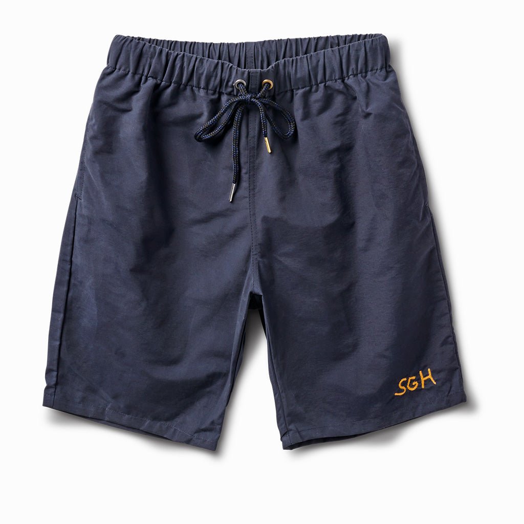 Indigo navy swim and wear trunks with a navy drawcord and gold SGH embroidery, front view