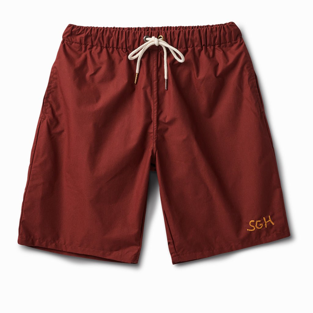 Ox blood swim and wear trunks with a cream drawcord and gold SGH embroidery, front view