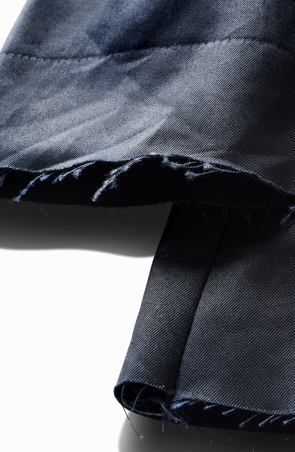 Close-up of the waxed indigo chino's frayed raw hem